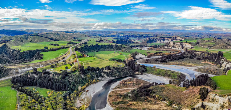 an aerial landscape panorama image of a meandering river on a mountain plateau in a summer day in New Zealand