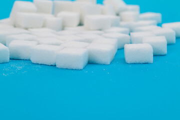 Sugar cubes on blue background