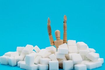 A puppet drowning in sugar cubes