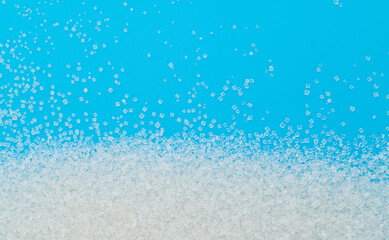 White sugar crystals on blue background