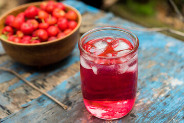 Glass of sour cherry juice with fresh red cherries, Cherry juice, on wood background, red drink, High vitamin C and antioxidant fruits.