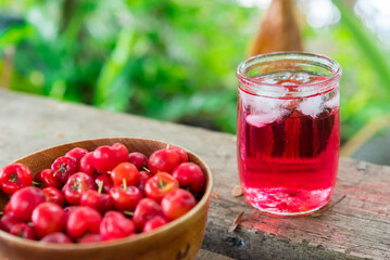 Glass of sour cherry juice with fresh red cherries, Cherry juice, on wood background, red drink, High vitamin C and antioxidant fruits.