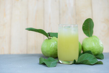 Guava juice, Guava water with Guava fruit, high Vitamin C, green drink, on wood background