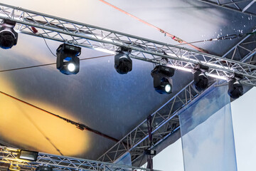 professional stage spotlight equipment on outdoor concert stage. spotlights on a stage lighting rig.