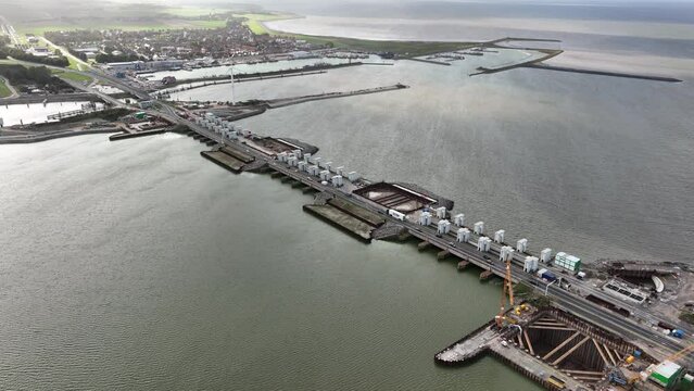 Afsluitdijk construction on pumping stations new sluices and the A7 near Den Oever, Kornwerderzand , and Zurich. Lock for shipping, road traffic cyclists and walkers. Aerial drone view.