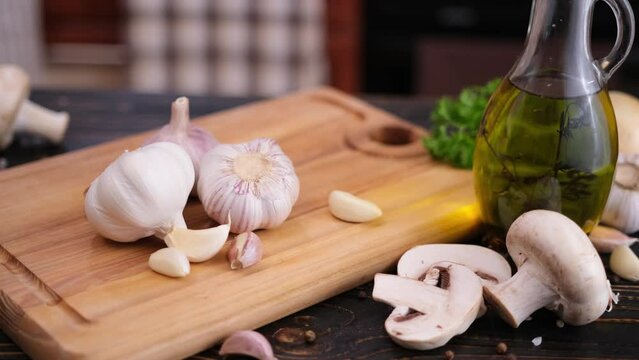 garlic on wooden cutting board at domestic kitchen