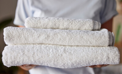 Woman, towels or laundry cleaning for hotel housekeeping maid, home cleaner service or relax resort...