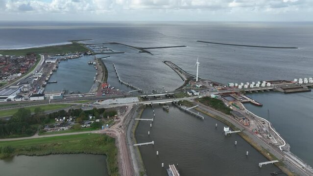 Afsluitdijk construction on pumping stations new sluices and the A7 near Den Oever, Kornwerderzand , and Zurich. Lock for shipping, road traffic cyclists and walkers. Aerial drone view.