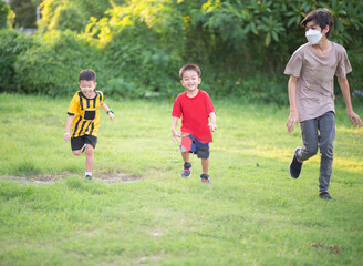 Fototapeta premium Asian Family play together at playground with happy smile