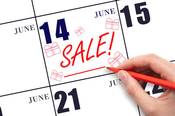 Hand writing text SALE and drawing gift boxes on calendar date June 14. Shopping Reminder