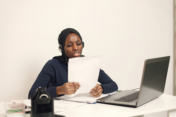 Arabic entrepreneur working on a laptop in her office