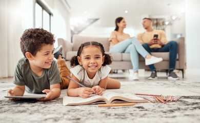 Happy family, learning and kids on a floor, drawing, bonding and relax with parents on sofa in the background. Children, learning and family quality time in a living room with boy and girl having fun