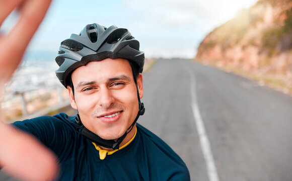 Selfie, fitness and man cycling in the road on the mountains in Switzerland for adventure, peace and freedom. Face portrait of a young, happy and free athlete with photo while training in the street