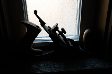 A close up image of a vintage hand planner tool on a wooden window sill. 