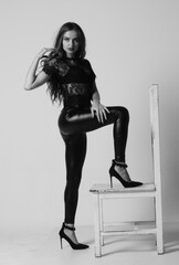 Stunning brunette beauty sitting on a chair