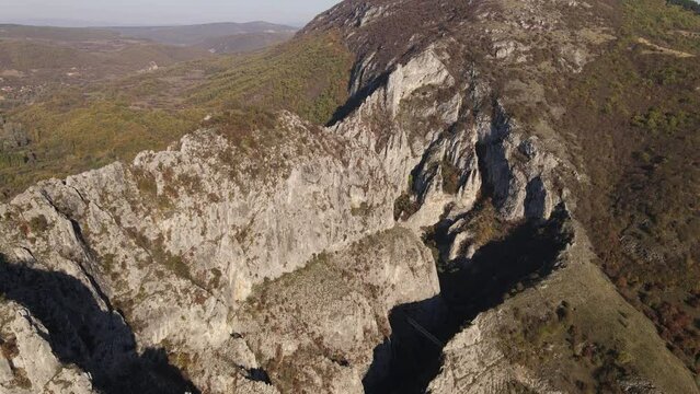 Stone rocks of the Nisevac near Svrljig in Serbia cliff and gorge rock on the mountain range in sunny day Aerial drone video over the hill