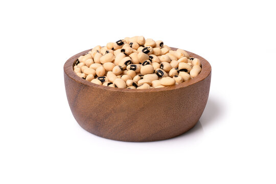 White cow pea beans (Black eye bean) in wooden bowl isolated on white background with clipping path. 