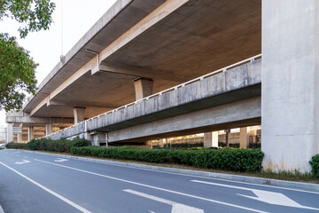 Concrete structure and asphalt road space under the overpass in the city