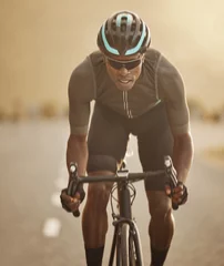 Foto auf Glas Fitness, sports and cycling man workout in a road at sunset, health, wellness and morning cardio exercise. Energy, speed and focus power by athletic black man cycling on bicycle for marathon training © Beaunitta Van Wyk/peopleimages.com