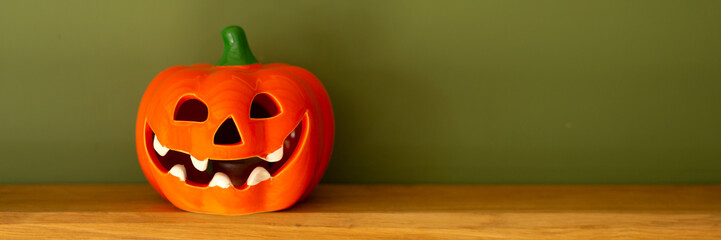 Pumpkin face banner on a wooden shelf