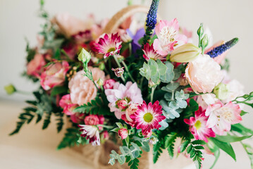 Beautiful pink flowers composition in the box close-up view. Festive decoration and background
