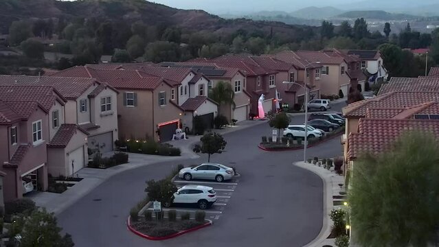 Aerial View of Santa Clarita Residential Community With Traditional Halloween Decorations in Front of Homes, Rising Drone Shot