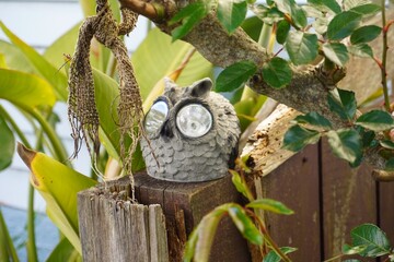 Owl Garden sculptures with LED eyes on fence posts