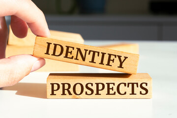 Wooden blocks with words 'Identify Prospects'.