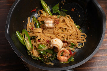 Stir-fried pasta with shrimp.dark background, top view