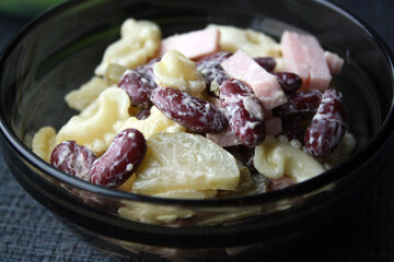 Salad of pasta, ham, beans and pickled cucumbers. Belgian cuisine.