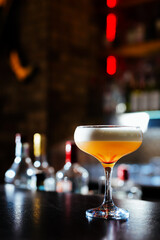 Champagne coupe glass of refreshing orange cocktail