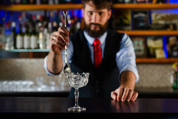 Barman preparing cocktail in night club