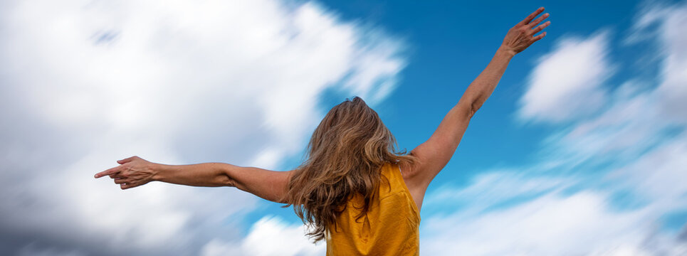 happy caucasian woman raising her hands up relax,  vacation time,  carefree girl concept