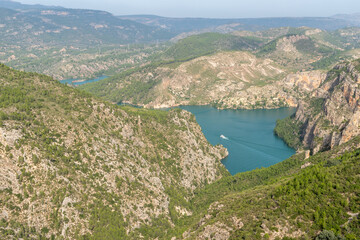 Fototapeta na wymiar Beautiful landscape photo of the cortes del pallas reservoir with a boat on the water and the surroundings with nature, Valencian community, Spain