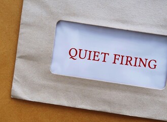 Office envelope with text QUIET FIRING, act of nudging an employee out of the workplace, a...