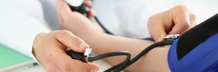 Doctor check blood pressure of patient in clinic, risk of hypertension, prevent disease