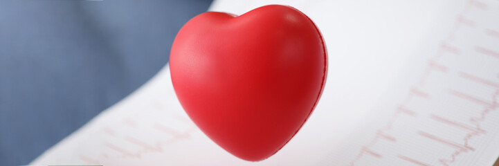 Red plastic heart with electrogram result, professional diagnostic