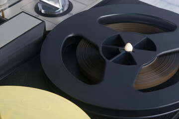 top view of an old magnetic tape recorder, close-up of coils and switches, background