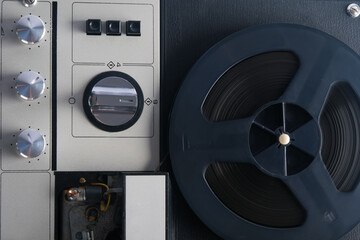 top view of an old magnetic tape recorder, close-up of the reel and switches