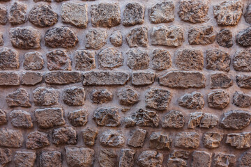 Close-up of the stone wall. Grey 
 stone wall background. 