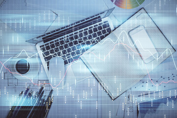 Multi exposure of forex chart drawing over table background with computer. Concept of financial research and analysis. Top view.