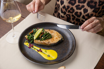 salmon steak on a plate, in a restaurant
