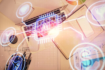 Double exposure of data drawing hologram over topview of study desk background with computer. Concept of Ai.