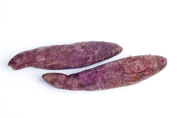 two long purple sweet potatoes on white background