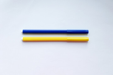Two blue-yellow pencils on a white background as the flag of Ukraine