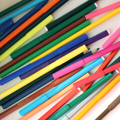 Set of colored pencils and felt-tip pens, preparation for school, many different pencils on white background, close-up