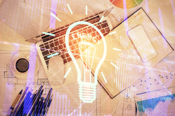 Bulb drawing over computer on the desktop background. Top view. Double exposure. Idea concept.