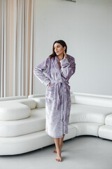 Young healthy serene woman girl relaxing in bathrobe and spa towel after having bath shower at home. Beauty treatment, rest and body care procedures.