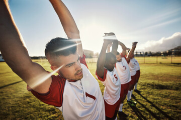 Men football, team and stretching for fitness, wellness and health on a sports field in the...
