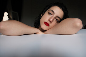 Obraz premium Young woman with calm face expression, looking at the camera. Mental issues.